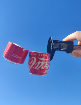 Visual comparison of outdoor umbrella rib thickness and soft drink can