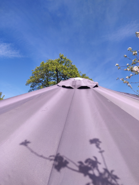 Faded outdoor umbrella fabric showing stripes after sun exposure